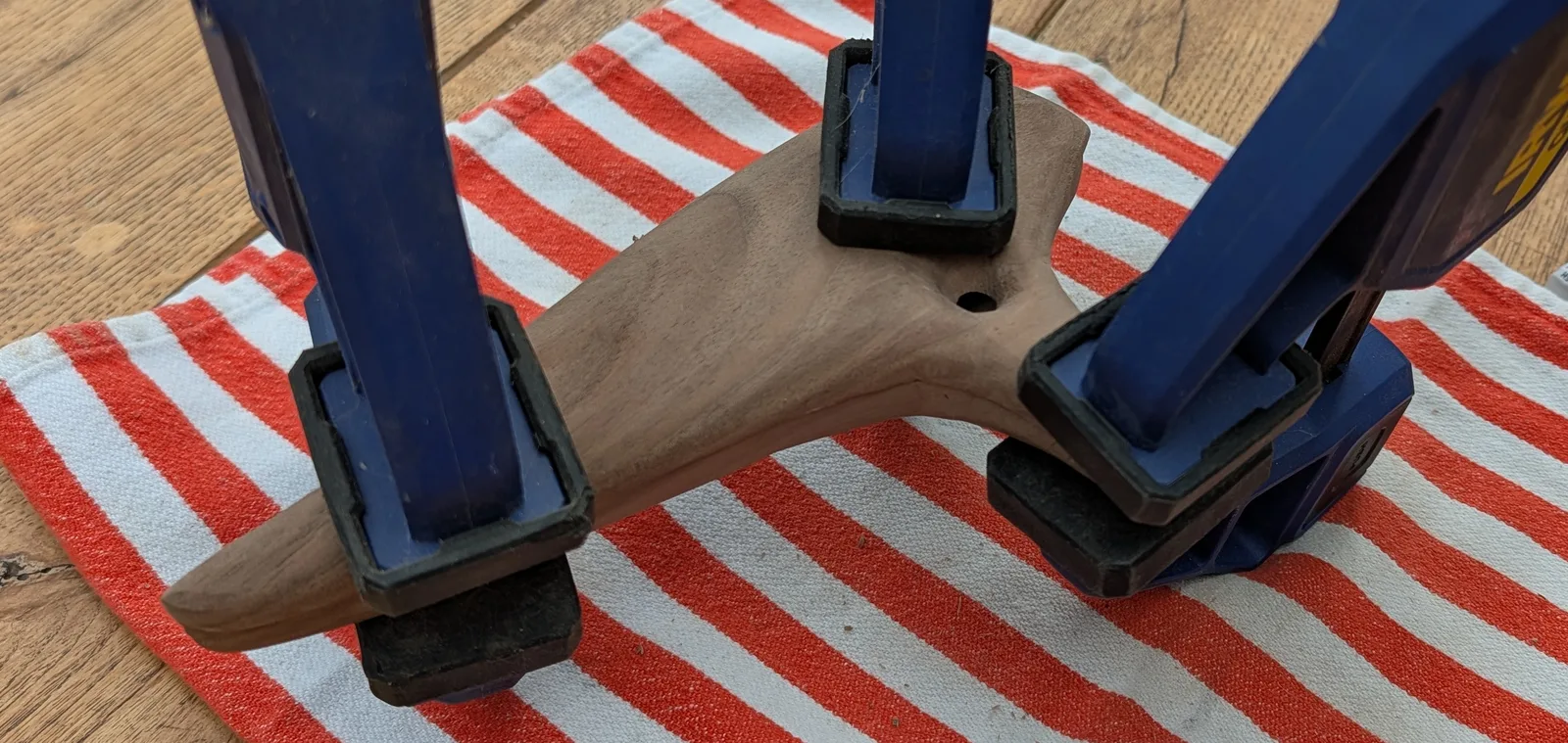 a photo of the two halves of the ocarina being glued, clamped tightly
