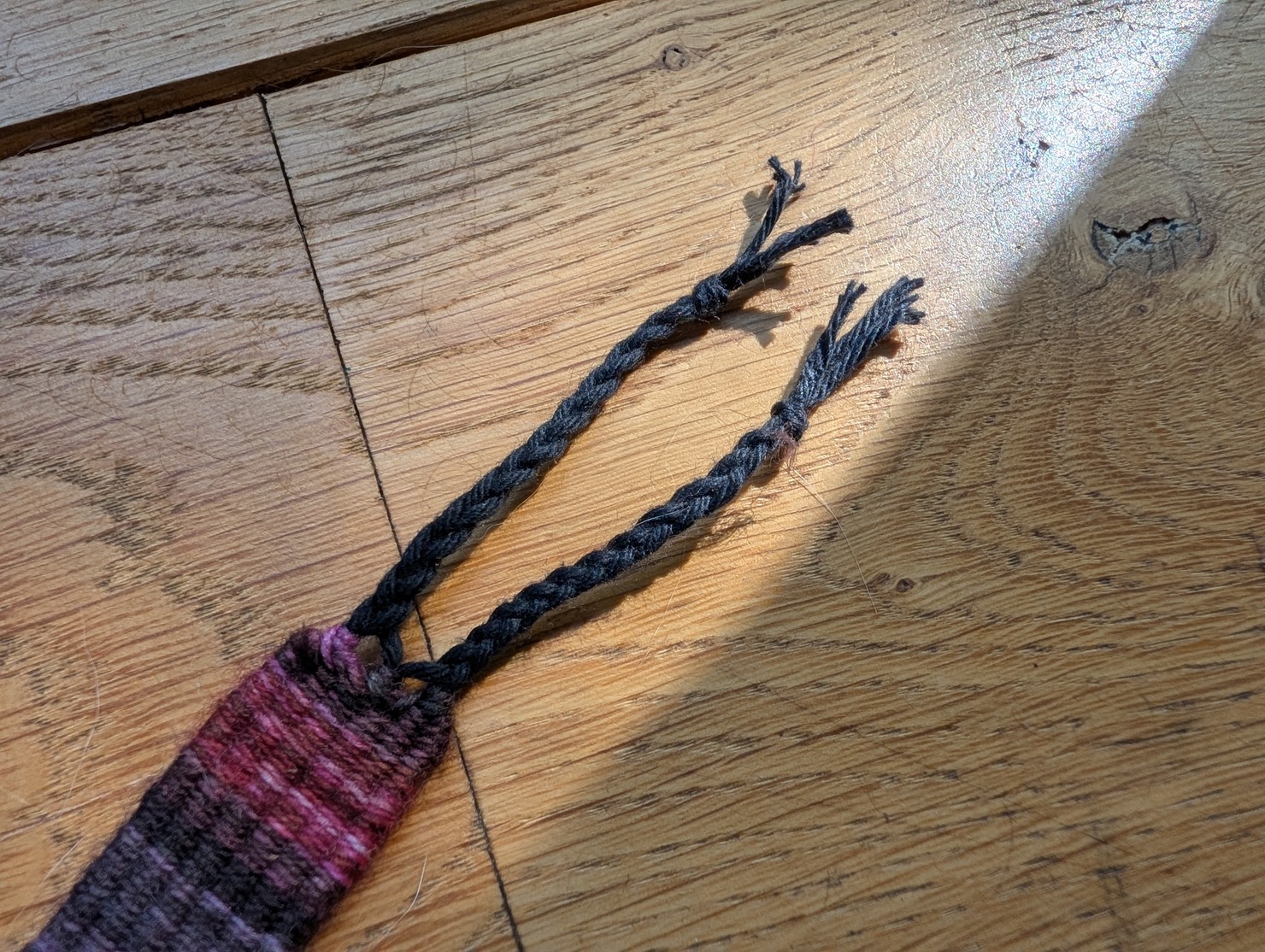 photo of six warp threads tied into two braids
